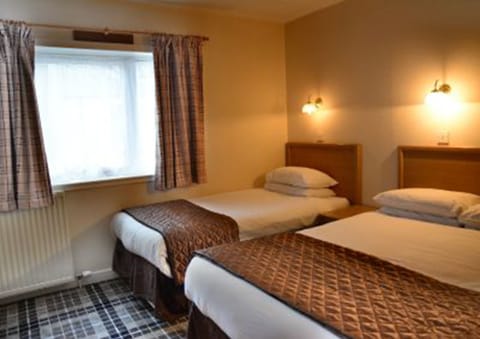 Standard Triple Room | Blackout drapes, iron/ironing board, free WiFi, bed sheets