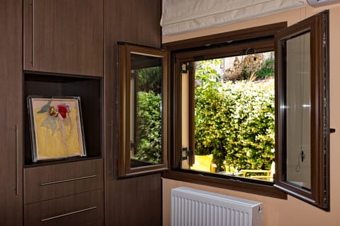 This bedroom has views of the blooming garden and easy access to it!!!!!
