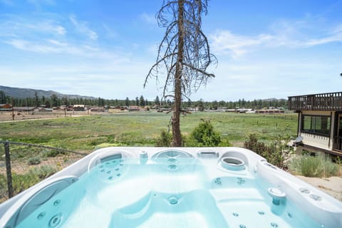 Private Hot Tun with INCREDIBLE Views. - Outdoor Gas Fire pit with seating next to a private hot tub and enclosed backyard.