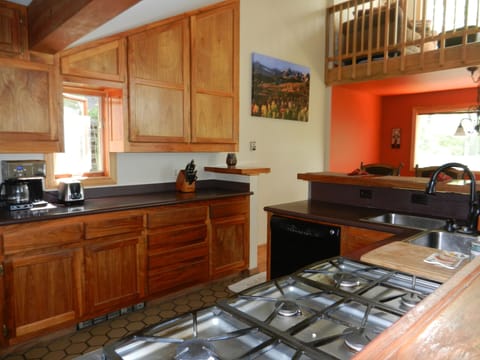 Kitchen with 6 burner gas stove.