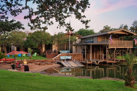 Lush green grass , shaded oak trees . Outdoor lighting .