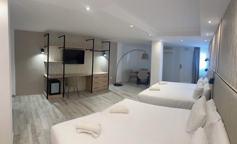 Deluxe Quadruple Room with Free Airport Shuttle | Minibar, in-room safe, individually decorated, individually furnished