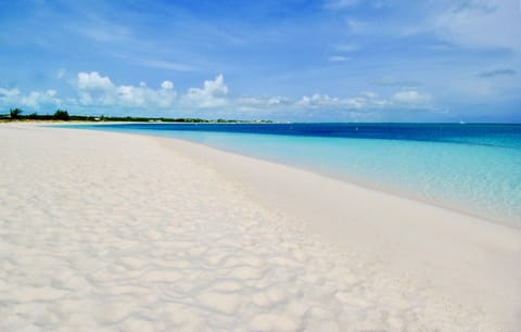 On the beach, white sand, sun loungers, beach umbrellas