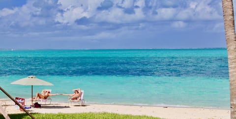 On the beach, white sand, sun loungers, beach umbrellas