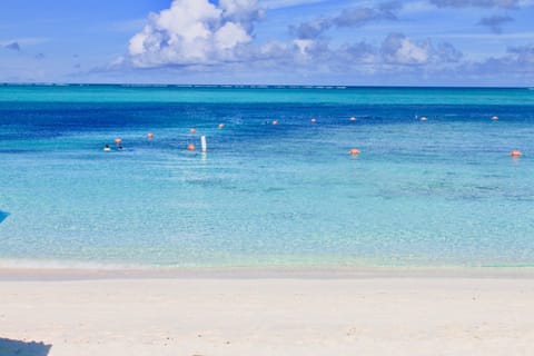 On the beach, white sand, sun loungers, beach umbrellas