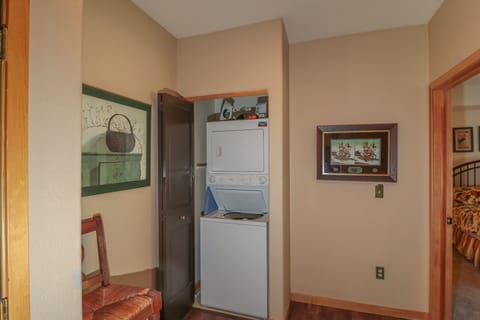 Stackable washer dryer in the condo. Iron and ironing board.