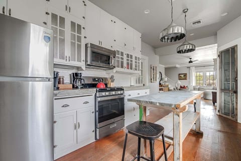 Kitchen includes an oven, microwave, full fridge and coffee maker.