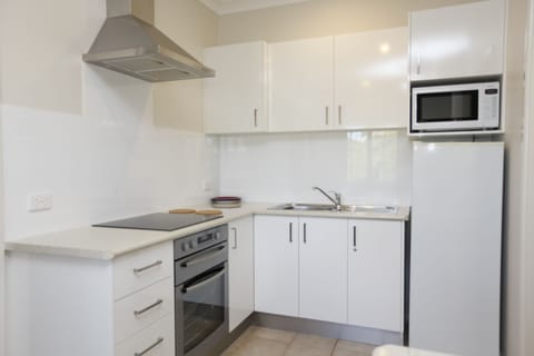 2-Bedroom Apartment A | Private kitchen | Full-size fridge, microwave, oven, stovetop