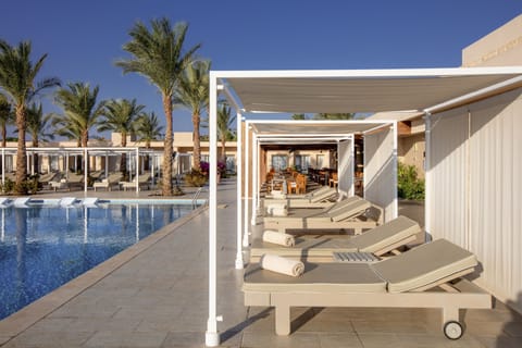 Outdoor pool, open 7 AM to 6:00 PM, pool umbrellas, sun loungers