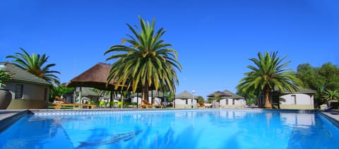 Outdoor pool, open 8 AM to 7 PM, pool umbrellas, sun loungers