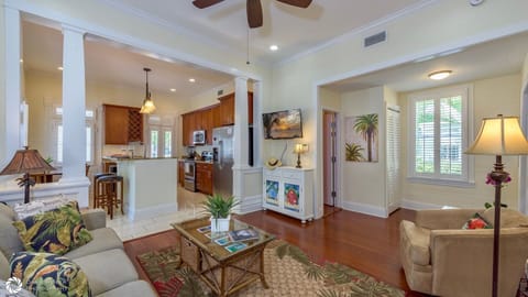 The living area has an open concept with a large flat screen TV...