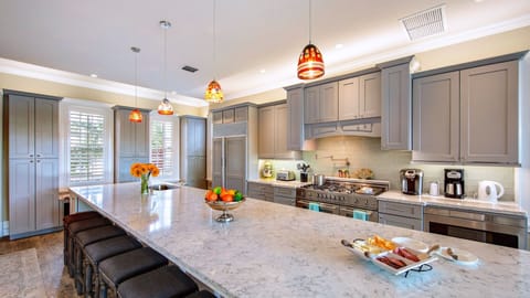 The custom kitchen is fully equipped with top-of-the-line stainless steel appliances...