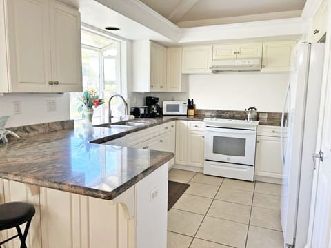 Kitchen is fully equipped witth pots, pans & appliances