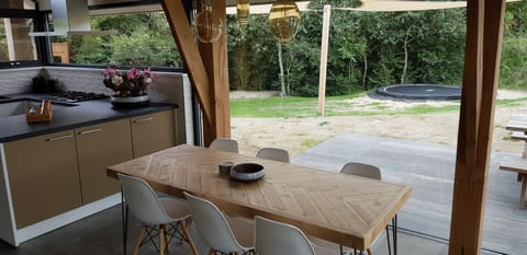 The huge glass fronts and timber merge the holiday home with the nature reserve.