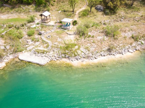 Aerial view of the shoreline and gazebo below the home
