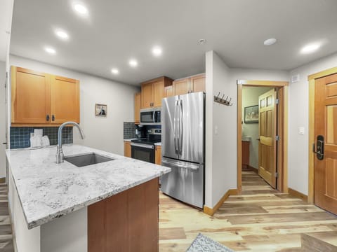 Modern kitchen with stainless steel appliances.