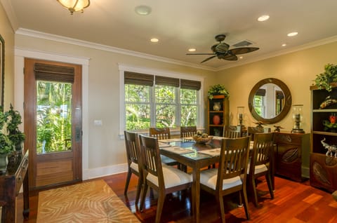 Dining Room - The back door opens to the dining area, with a table and seating for eight, with lush garden views.