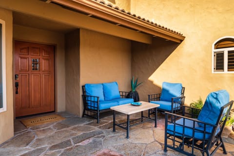 Front Patio - Enticing bright blue cushions await your arrival.
