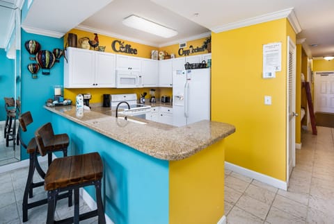 Kitchen - You have extra cooking space here. The smooth range stove makes cooking a breeze. Fun & cheerful decor throughout to pick up your spirits-after all, you are in PARADISE!