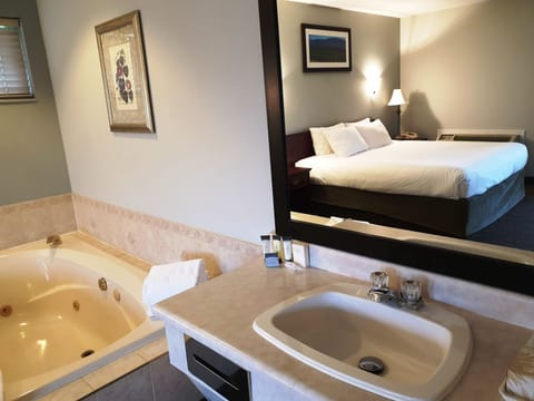 Suite, 1 King Bed, Jetted Tub, River View | Iron/ironing board, free WiFi, bed sheets