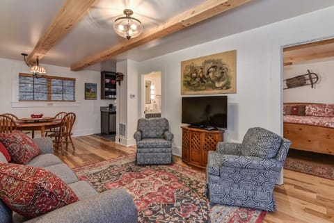 Living Room with flat screen TV, pull out queen sofa and swivel chairs.