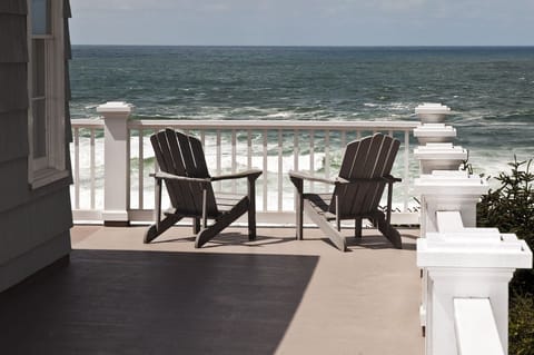 Deck view wraps around with 10 wooden chairs - Huge ocean views and 10 wooden chairs!