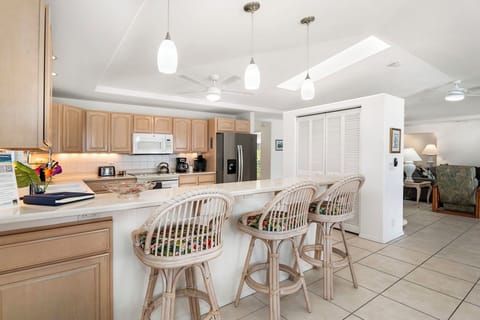 Fully equipped kitchen with a peninsula bar seating for three