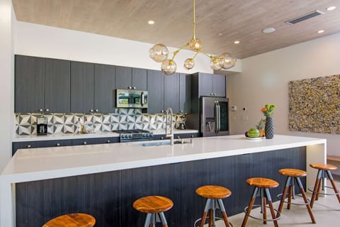 Chef's Black Stainless Kitchen with 14-Foot Island and Ample Seating