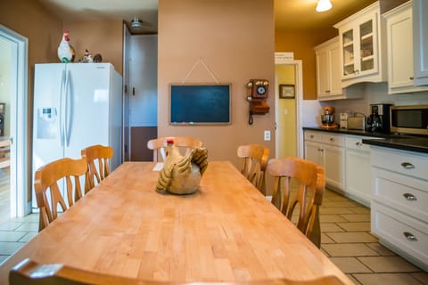 Kitchen - Cute decorations adorn the kitchen area, complete with a side-by-side refrigerator