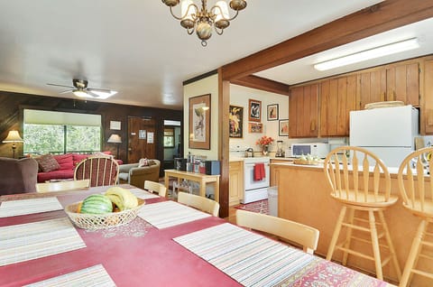 An open dining area with bar seating at the kitchen counter.