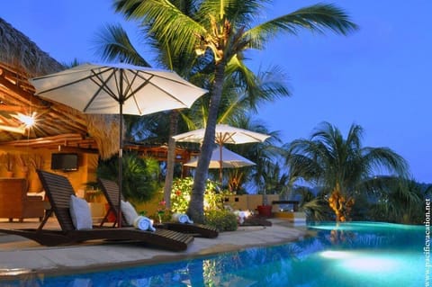 Poolside lounge area at night staypv.com