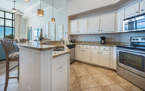 This kitchen features granite countertops, stainless appliances, and a cozy breakfast bar, perfect for preparing family meals
