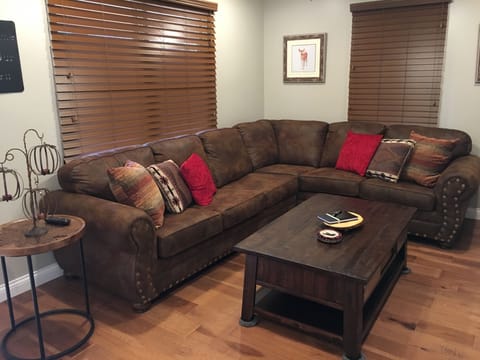 Living room area with sectional sleeper sofa. 55 inch flat screen with DISH