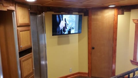 A flat screen television in the Queen sized mattress bedroom