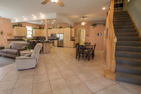 Main Level | Living Room - Walk into this massive beach home with a feel of the coast. Open floor plan perfect for your large group gatherings. A holiday favorite.