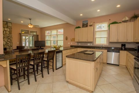 Main Level | Kitchen - The breakfast bar area has 6 extra chairs for additional seating. Need more? Not to worry! Just pull up a few more chairs and you are all set!
