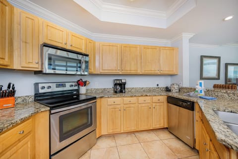 Inviting kitchen with stainless appliances, granite countertops, and a cozy coffee station for your morning brew