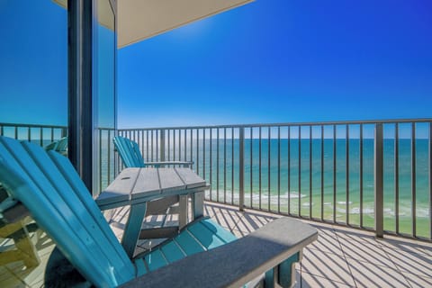 Relax on the turquoise chairs of this inviting balcony, offering breathtaking views of the sparkling waters below