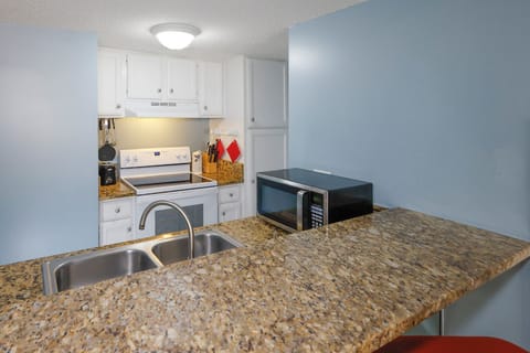 This kitchen features granite countertops, essential appliances, and a convenient layout for effortless meal preparation