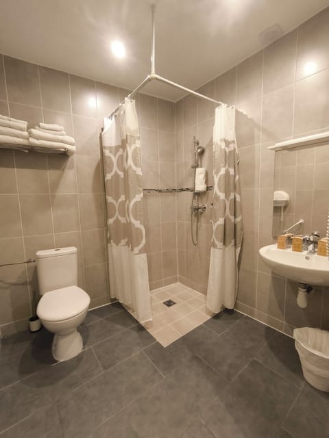 Economy Quadruple Room, Ground Floor | Bathroom | Shower, free toiletries, hair dryer, towels