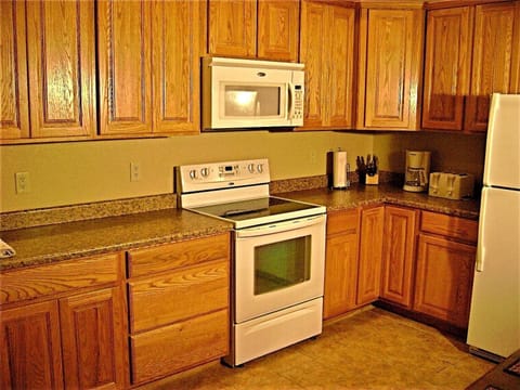 Fully equipped kitchen next to large capacity laundry room. Everything you need!
