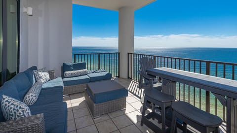 This balcony features modern outdoor furniture and seating arrangements with beach views from the sixteenth floor