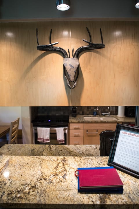 Dramatic lighting over the bar seating with some artistic metalwork