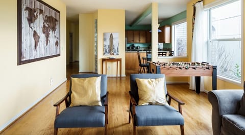 Living room has a foosball table, a TV, many Games and books to enjoy.