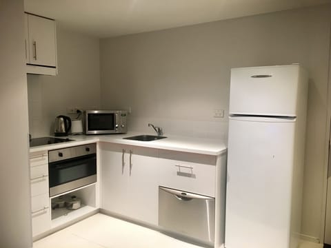 Suite, 1 Bedroom | Private kitchen | Fridge, microwave, stovetop, dishwasher