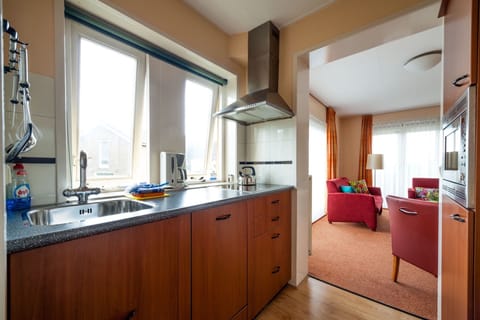 City Apartment, Balcony (11) | Private kitchen | Full-size fridge, microwave, stovetop, dishwasher