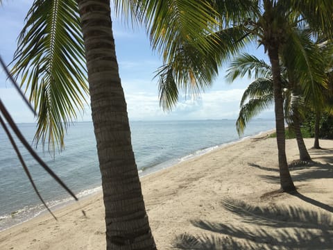 On the beach, white sand, sun loungers, beach umbrellas