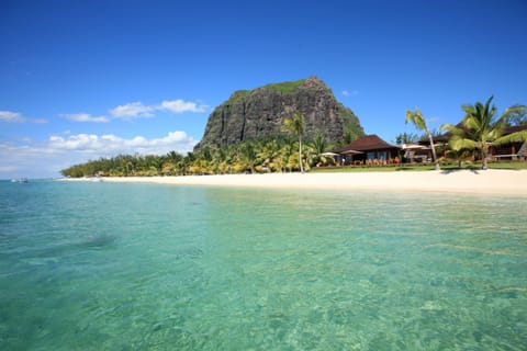 On the beach, white sand, sun loungers, beach umbrellas