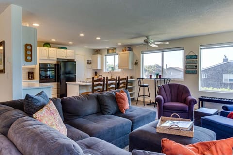 The open floor-plan provides wrap around views of treetops and crashing waves wherever you might gaze.