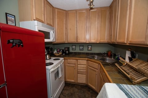 Full Kitchen: oven, microwave, place setting for 4, pots & pans, cooking utensil